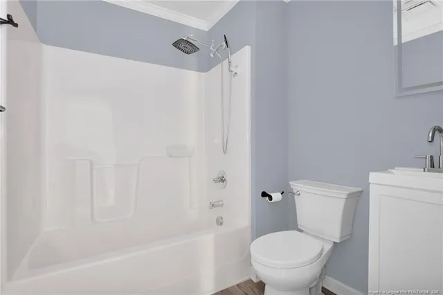 a white toilet sitting next to a bath tub