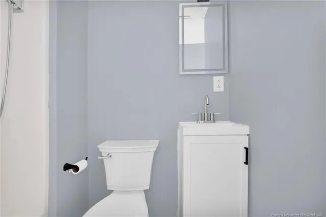 a white toilet sitting next to a white sink