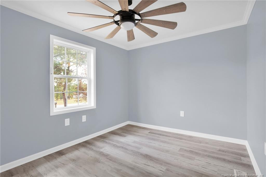 266 Brower Road Cameron, NC 28326 - Photo 22 of 26 an empty room with a window and a fan