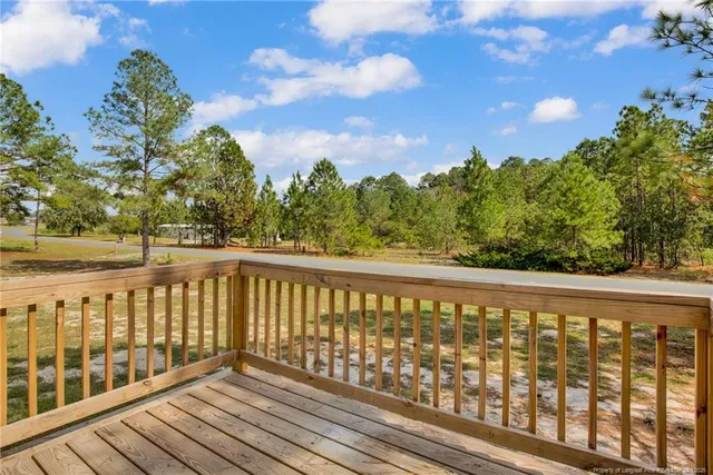 a balcony with wooden floor and fence