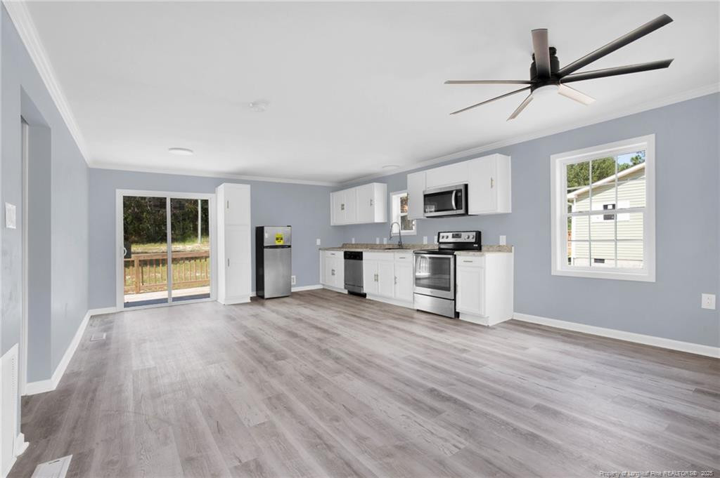 266 Brower Road Cameron, NC 28326 - Photo 10 of 26 a view of kitchen with microwave a stove and wooden floors