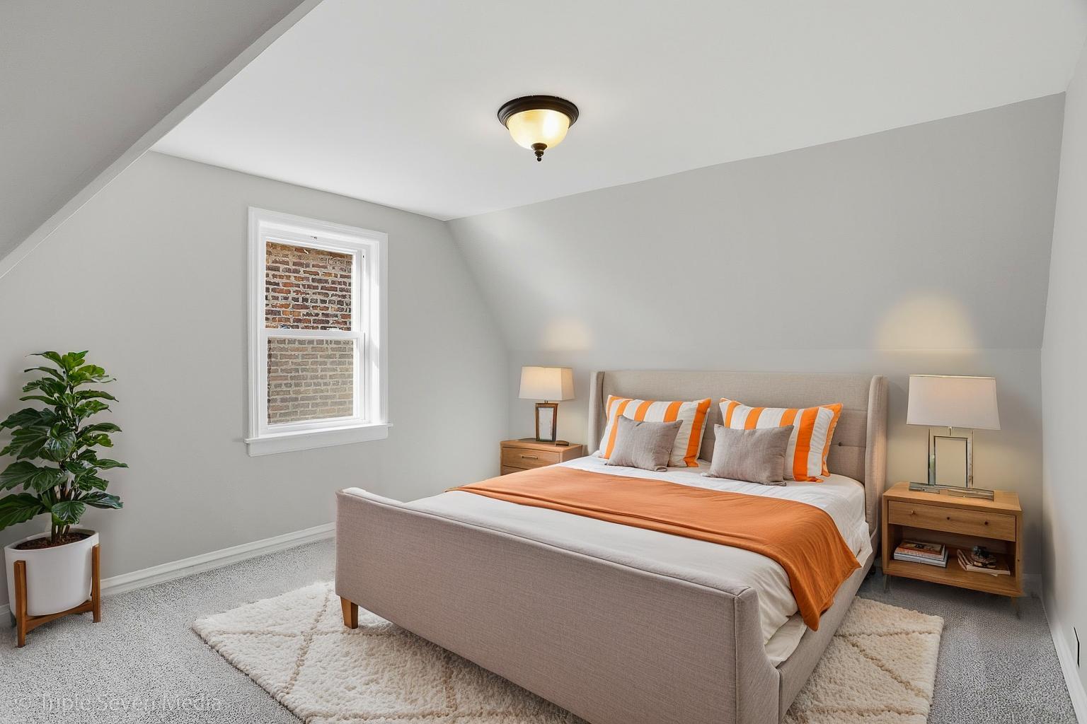 9149 South Aberdeen Street Chicago, IL 60620 - Photo 22 of 46 a bed sitting in a bedroom next to a window and a potted plant