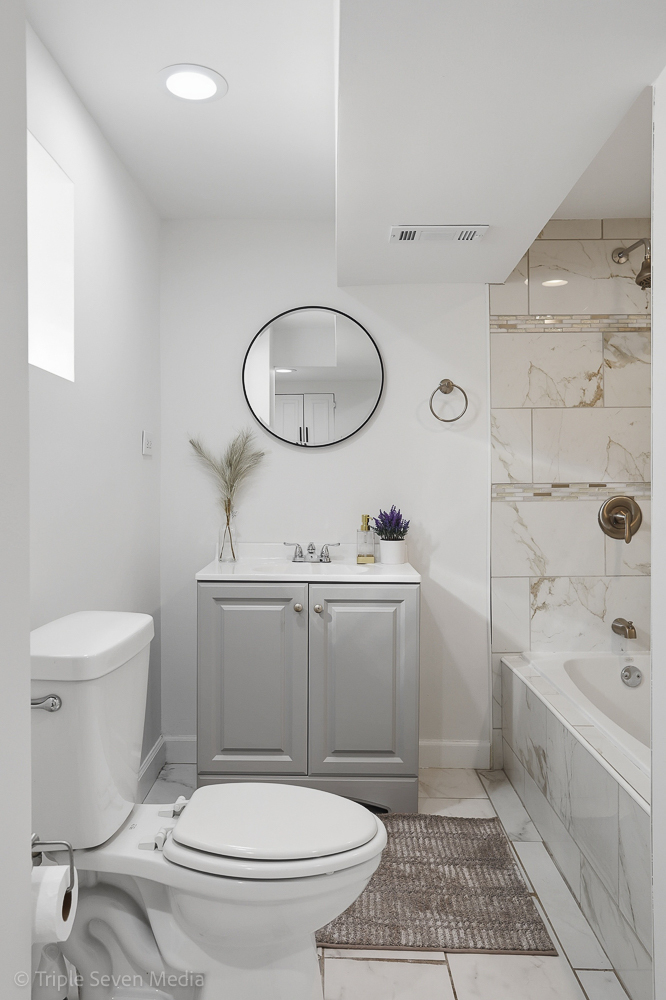 9149 South Aberdeen Street Chicago, IL 60620 - Photo 35 of 46 a bathroom with a toilet a sink and mirror
