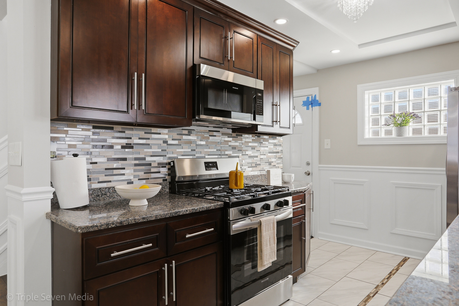 9149 South Aberdeen Street Chicago, IL 60620 - Photo 9 of 46 a kitchen with stainless steel appliances granite countertop a stove microwave and sink