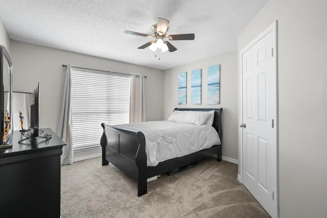 a bedroom with a bed and window