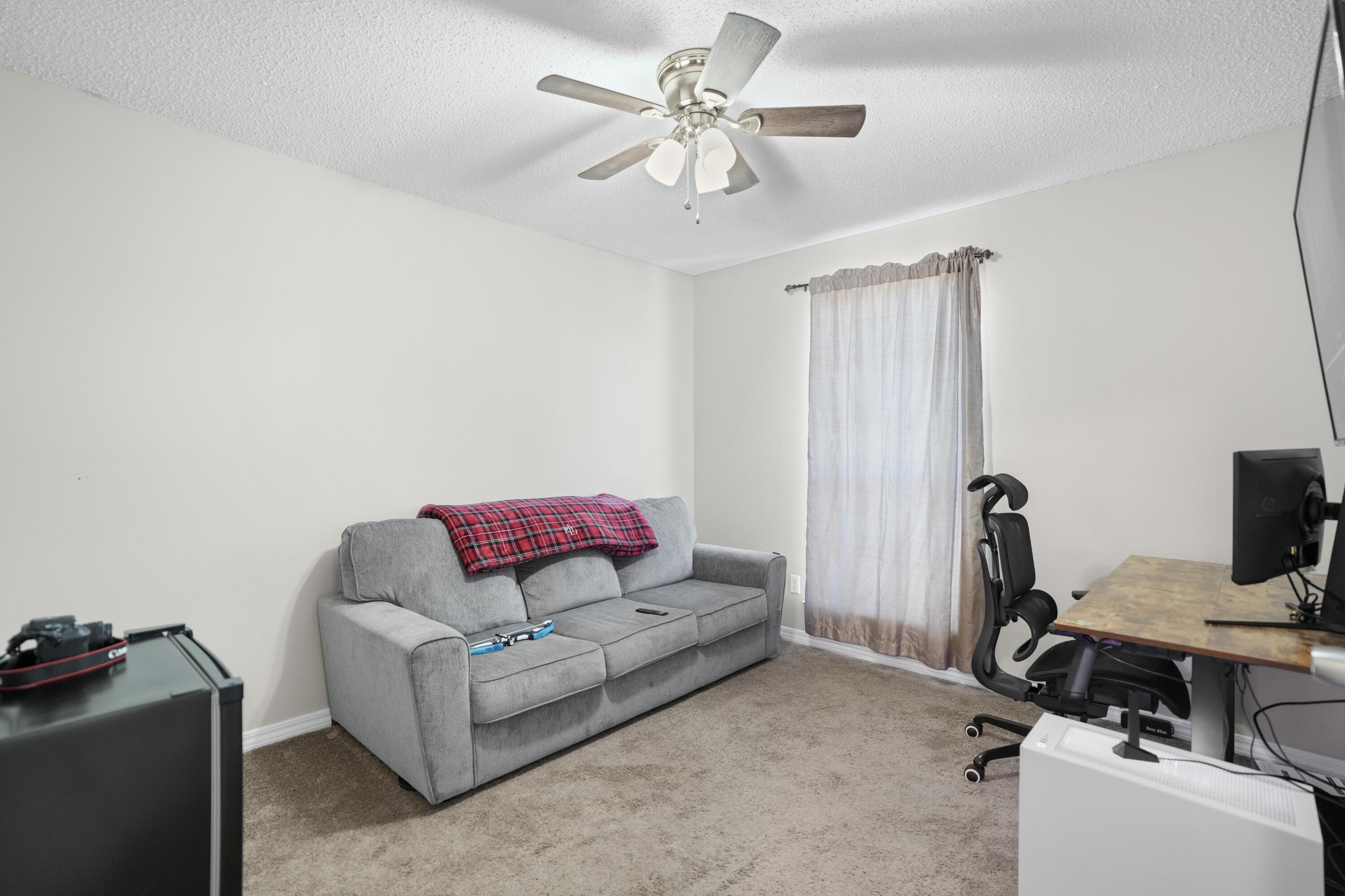 422 Jillian Drive Crestview, FL 32536 - Photo 15 of 26 a living room with furniture a ceiling fan and a window