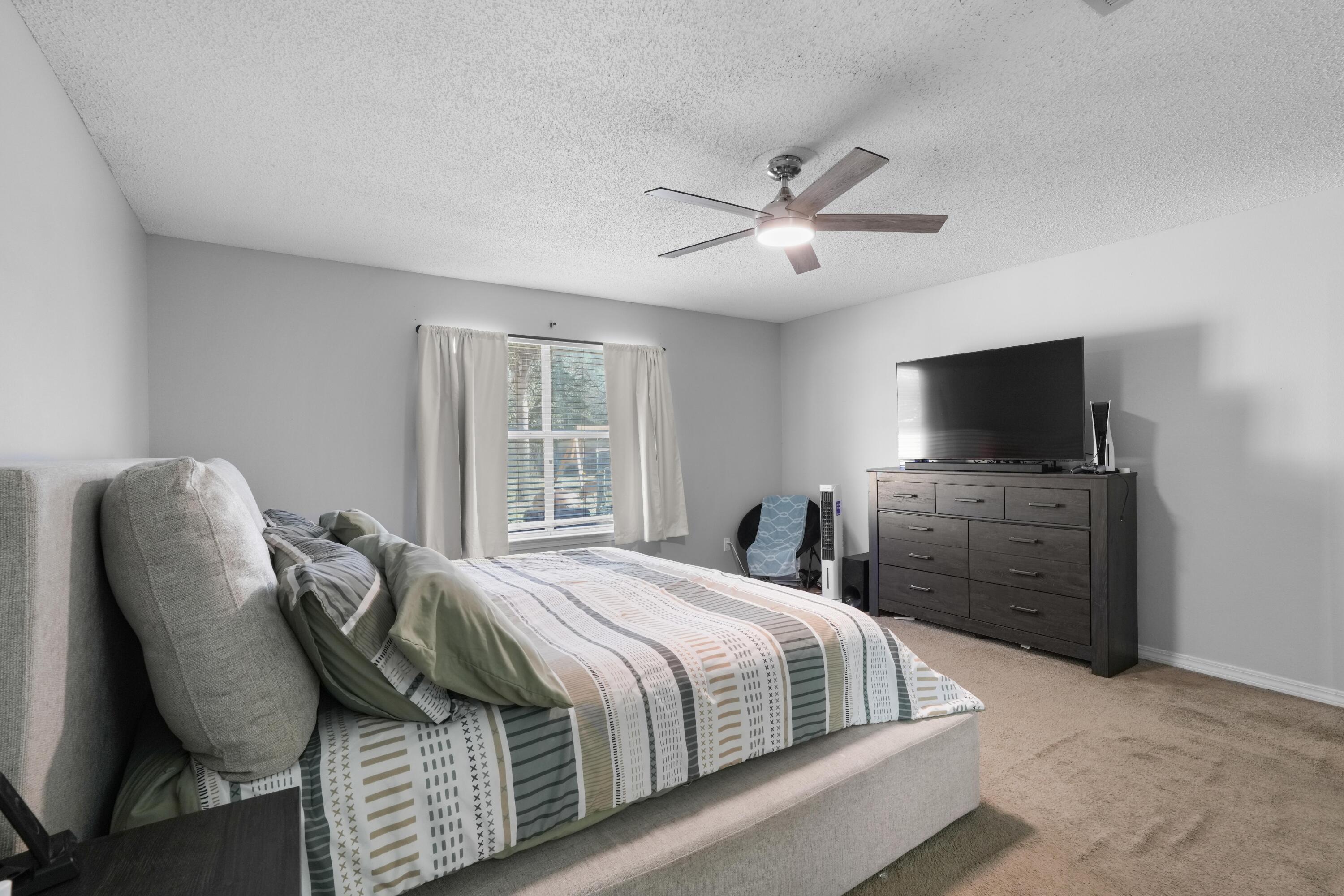 422 Jillian Drive Crestview, FL 32536 - Photo 19 of 26 a bedroom with a bed and a flat screen tv