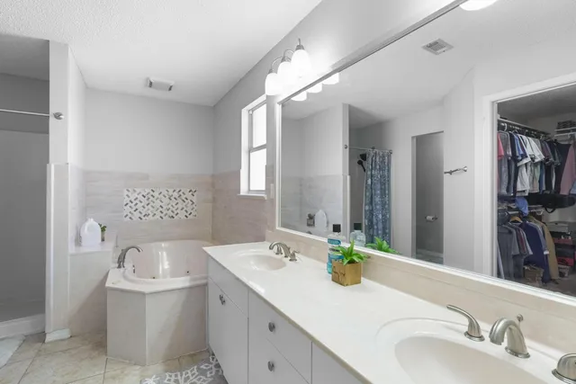 a bathroom with a sink double vanity and a mirror