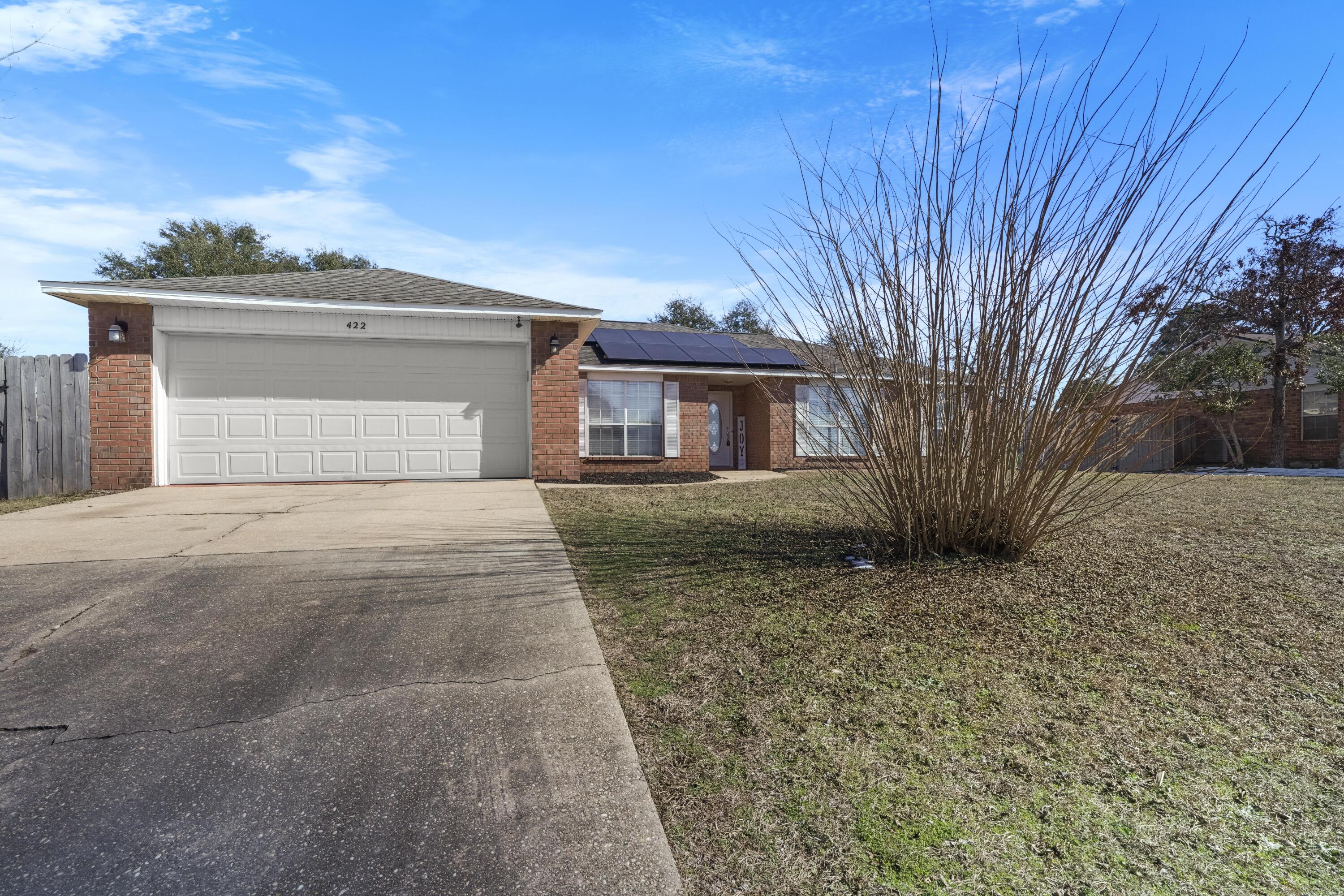 422 Jillian Drive Crestview, FL 32536 - Photo 2 of 26 a front view of a house with a yard and garage