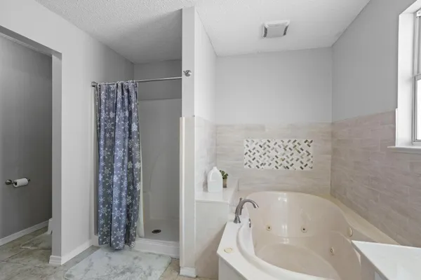 a bathroom with a bathtub and shower