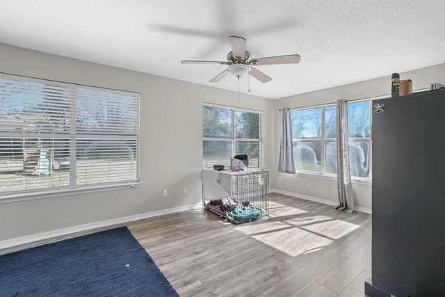 a living room with hard wood floors and a window