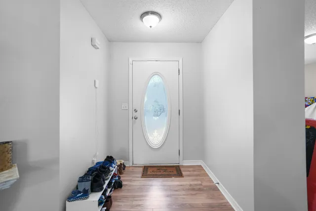 a view of a room with wooden floor and mirror