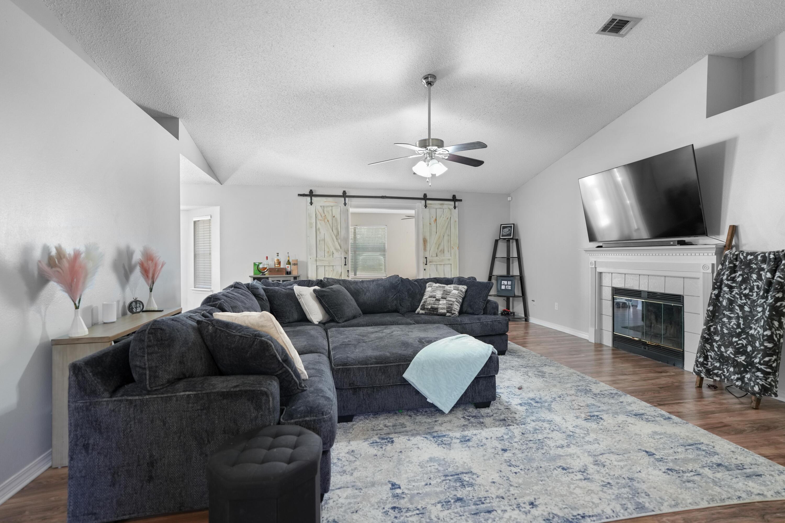 422 Jillian Drive Crestview, FL 32536 - Photo 5 of 26 a living room with furniture a fireplace and a flat screen tv