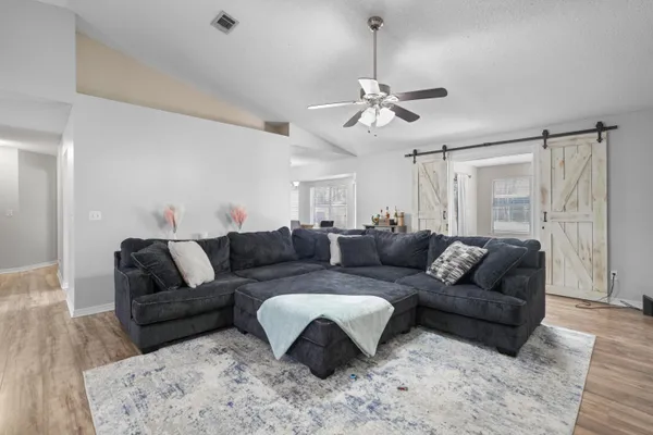a living room with furniture and a chandelier