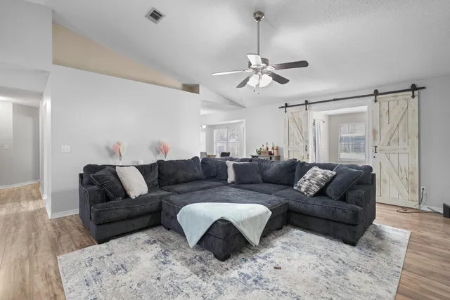 a living room with furniture and a chandelier