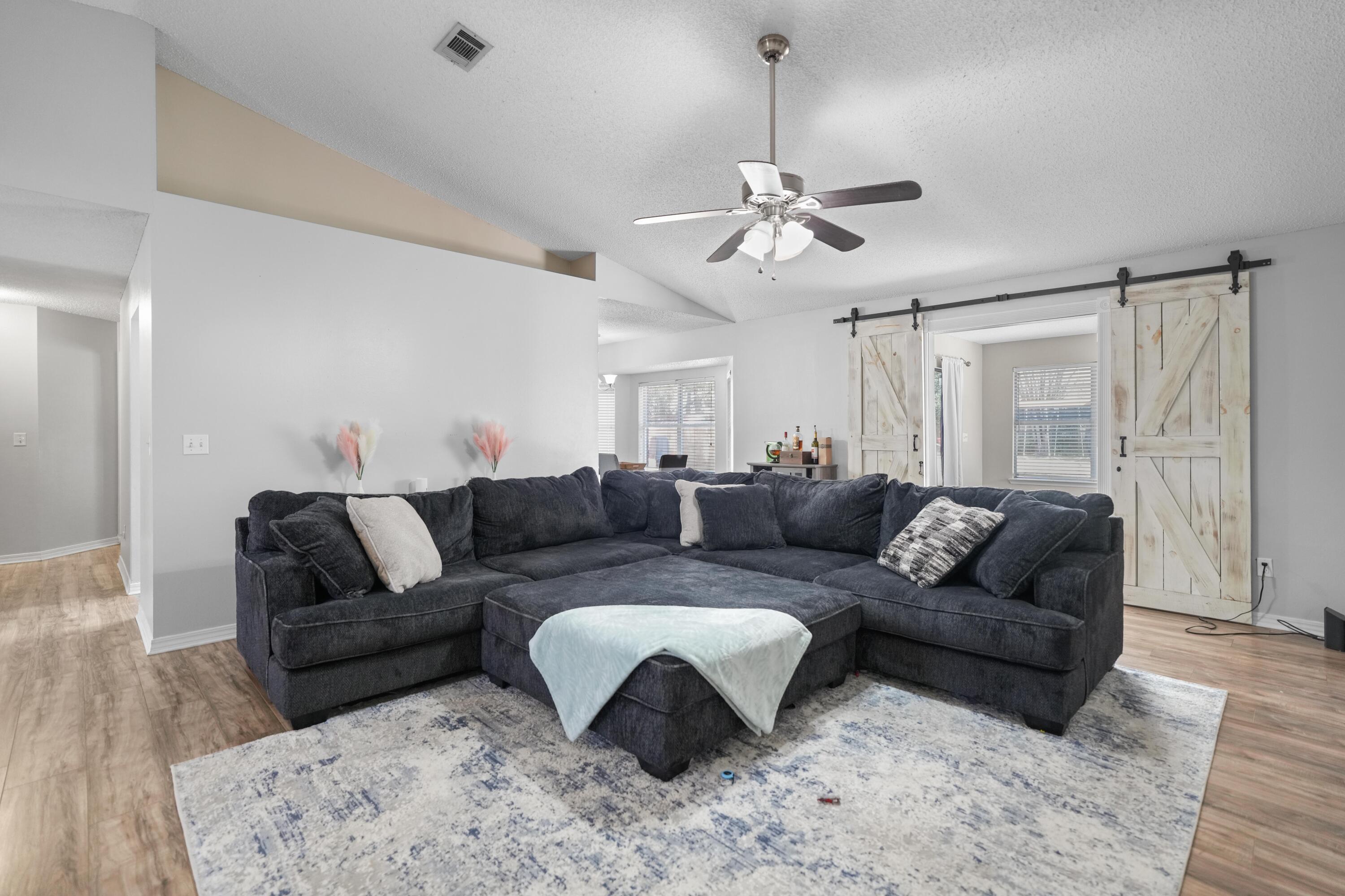 422 Jillian Drive Crestview, FL 32536 - Photo 8 of 26 a living room with furniture and a chandelier
