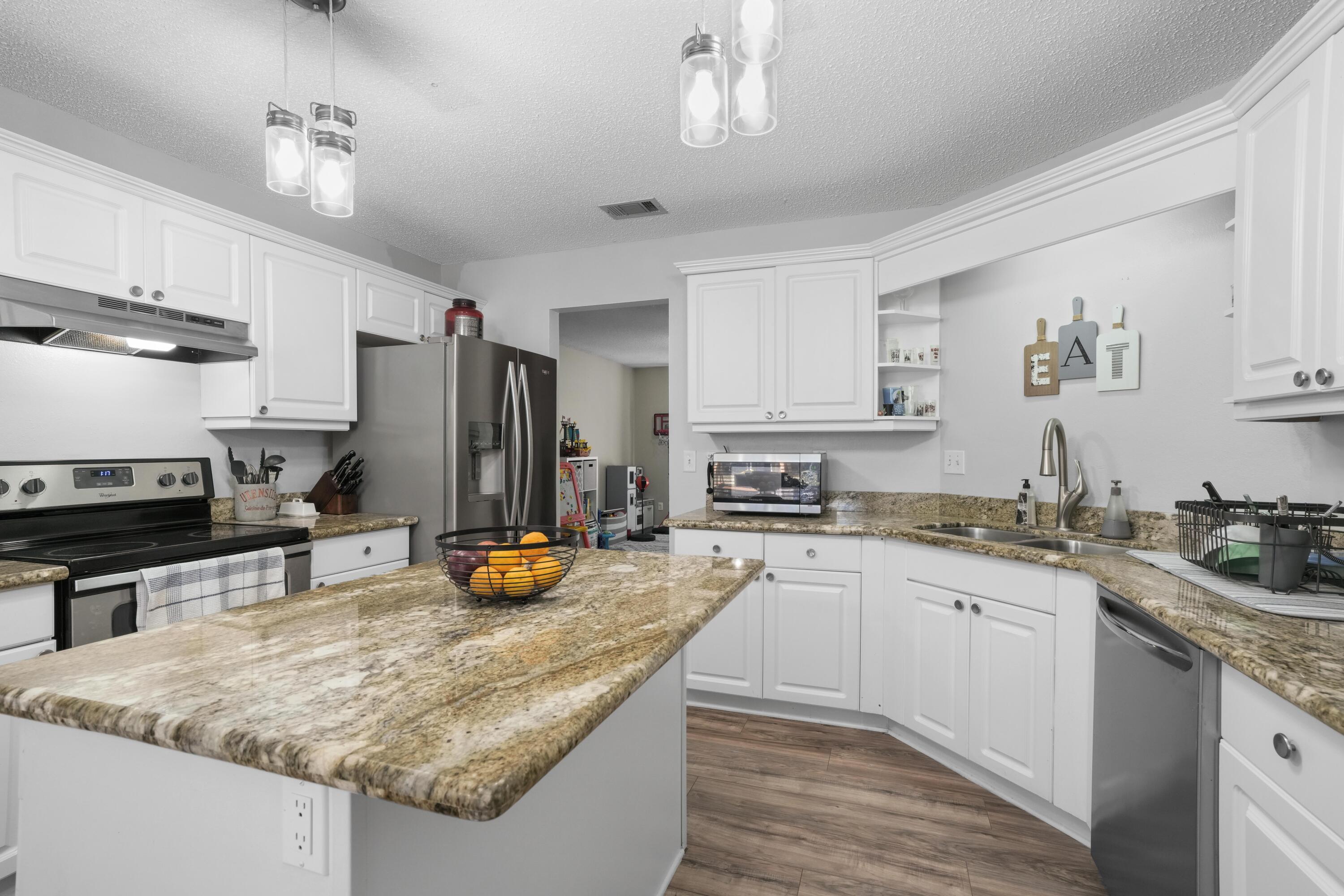 422 Jillian Drive Crestview, FL 32536 - Photo 10 of 26 a kitchen with a sink a stove and refrigerator