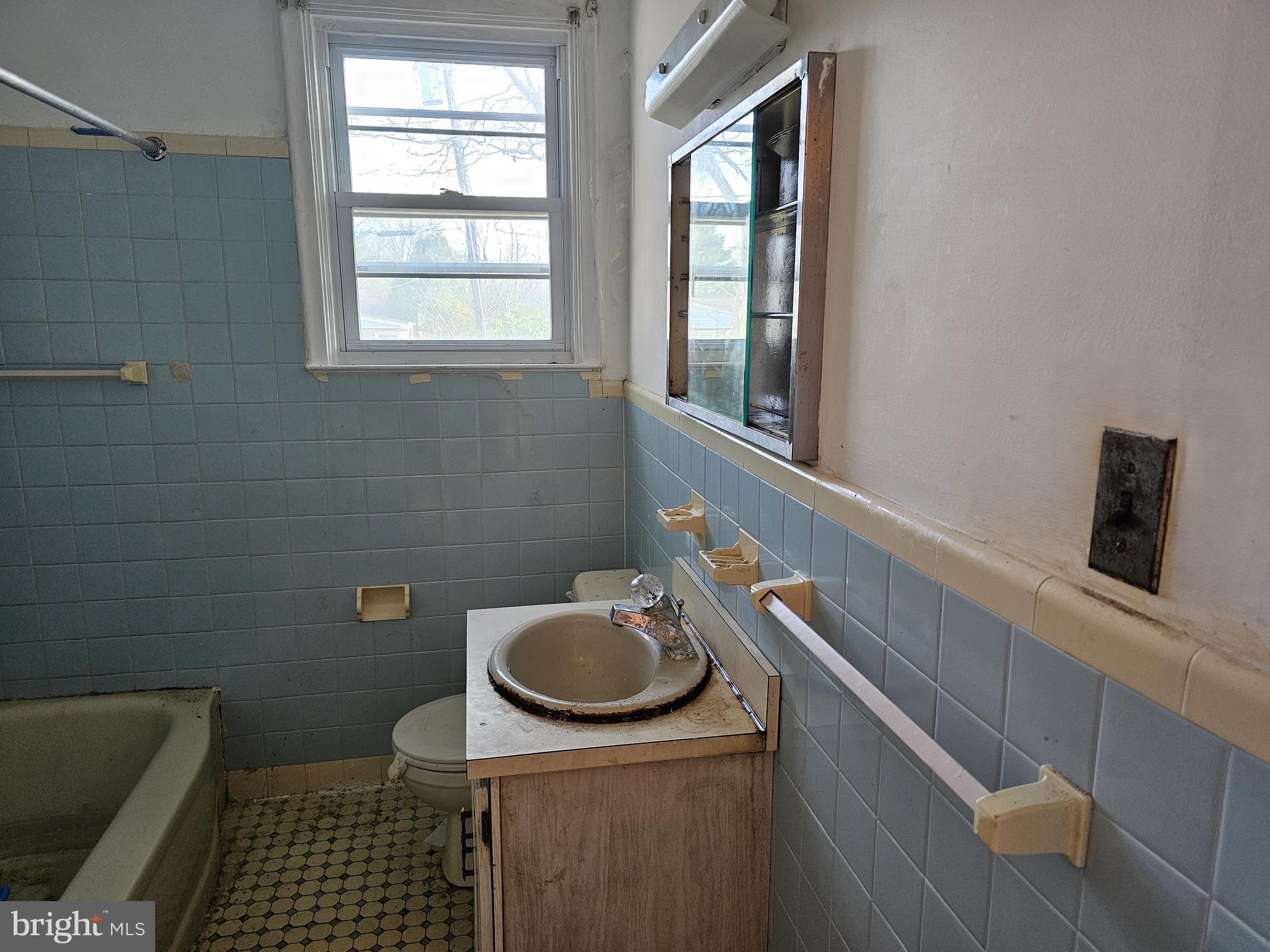4404 Miller Road Wilmington, DE 19802 - Photo 13 of 17 a bathroom with a sink a toilet and window