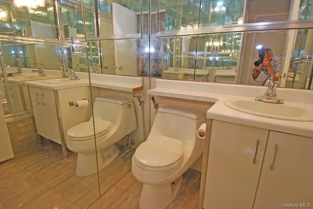 a bathroom with a toilet sink and mirror