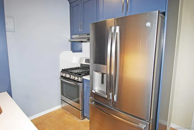 a kitchen with a refrigerator and a stove