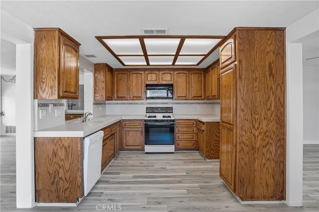 a kitchen with stainless steel appliances granite countertop a stove and a refrigerator