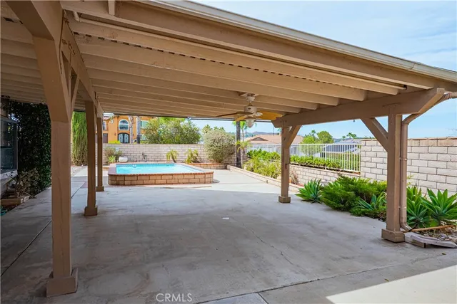 a view of patio with a table and chairs under an umbrella