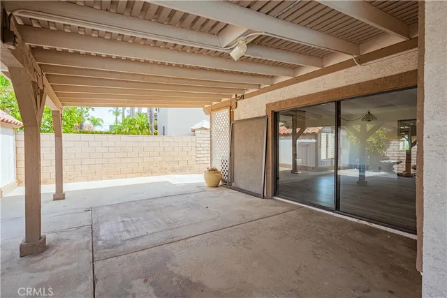 a view of balcony with wooden floor and a potted plant