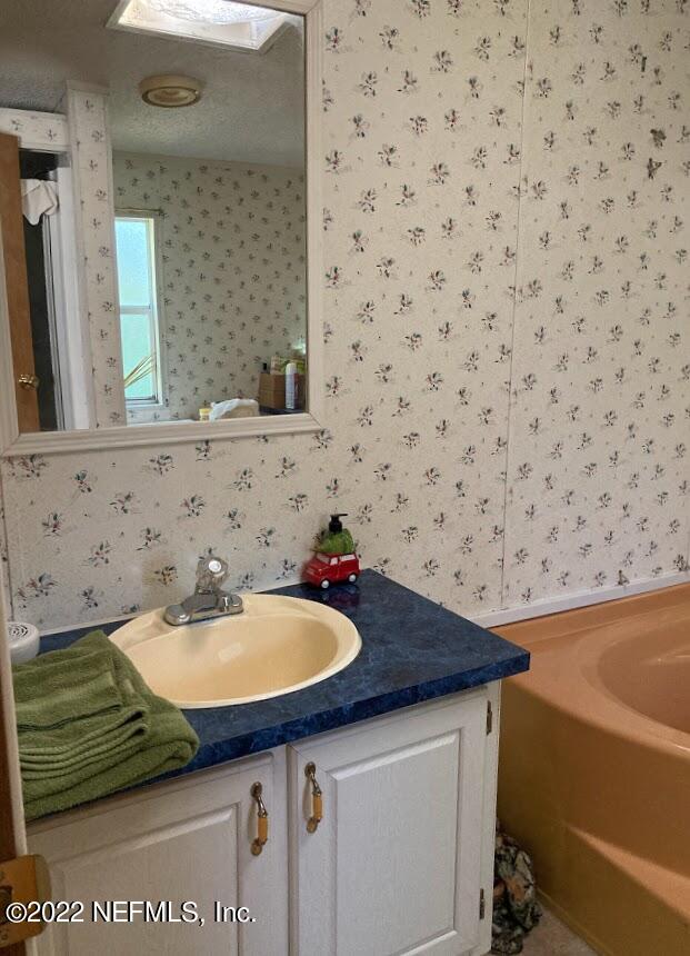3265 Stratton Road Jacksonville, FL 32221 - Photo 7 of 13 a bathroom with a sink and a mirror