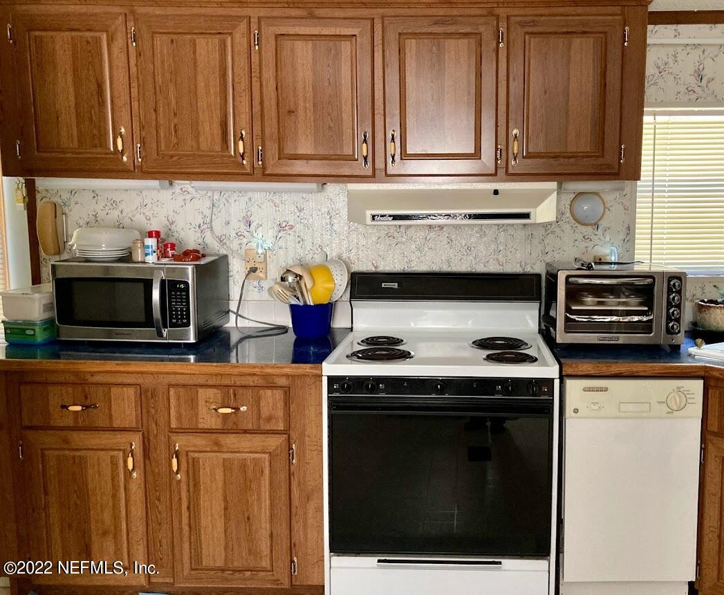 3265 Stratton Road Jacksonville, FL 32221 - Photo 8 of 13 a kitchen with granite countertop cabinets and steel stainless steel appliances