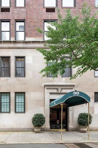 front view of a building with a garden