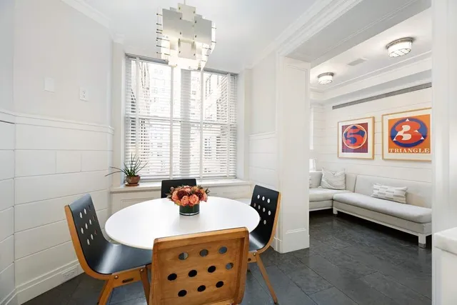 a reading room with furniture and a chandelier