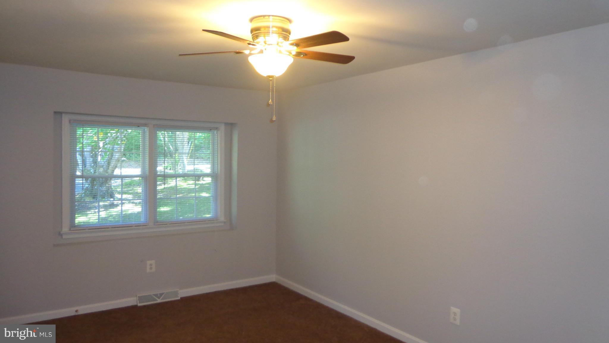 16286 Oak Shade Road Rixeyville, VA 22737 - Photo 11 of 24 an empty room with a window and a fan