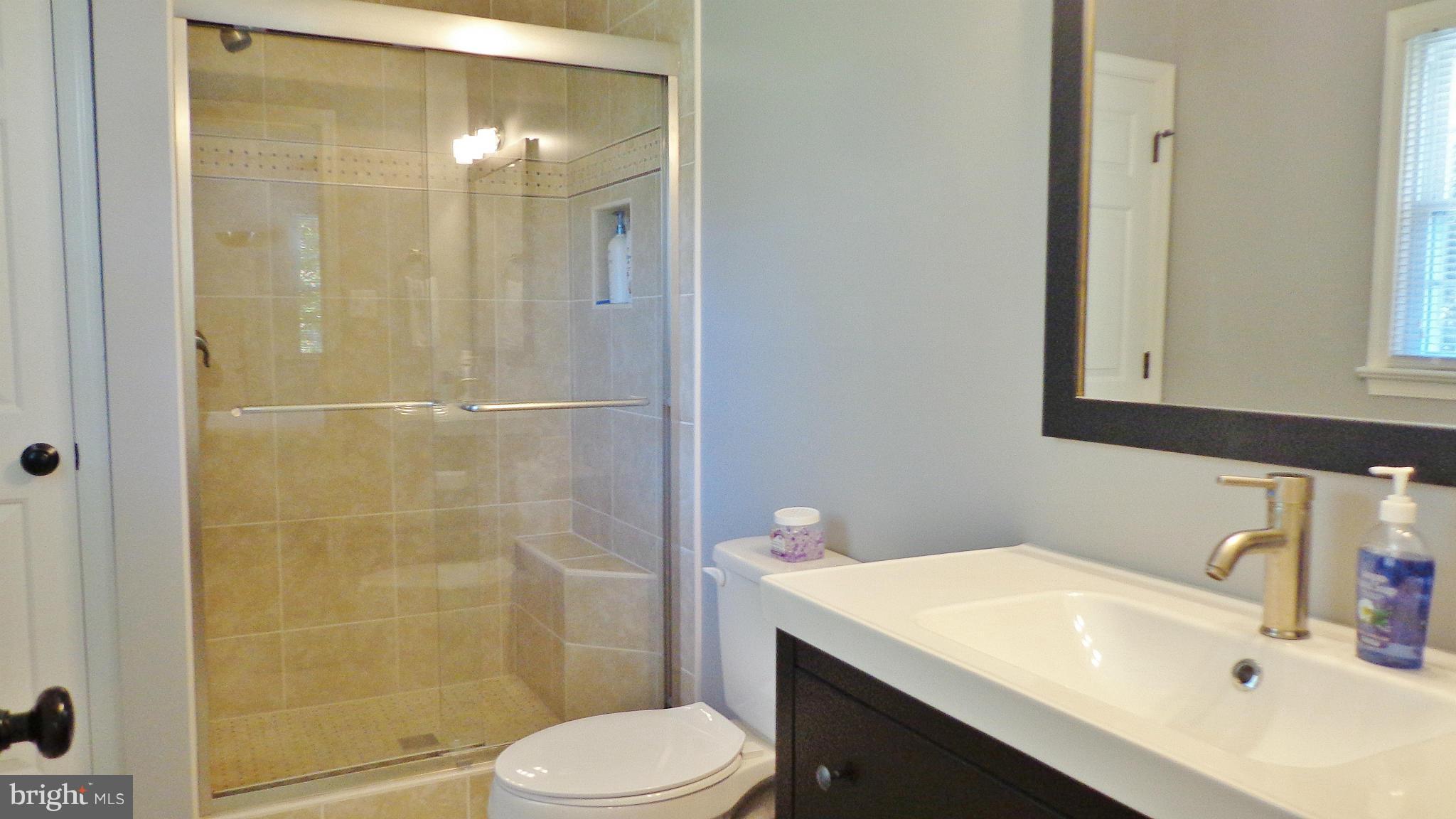 16286 Oak Shade Road Rixeyville, VA 22737 - Photo 13 of 24 a bathroom with a sink toilet and shower