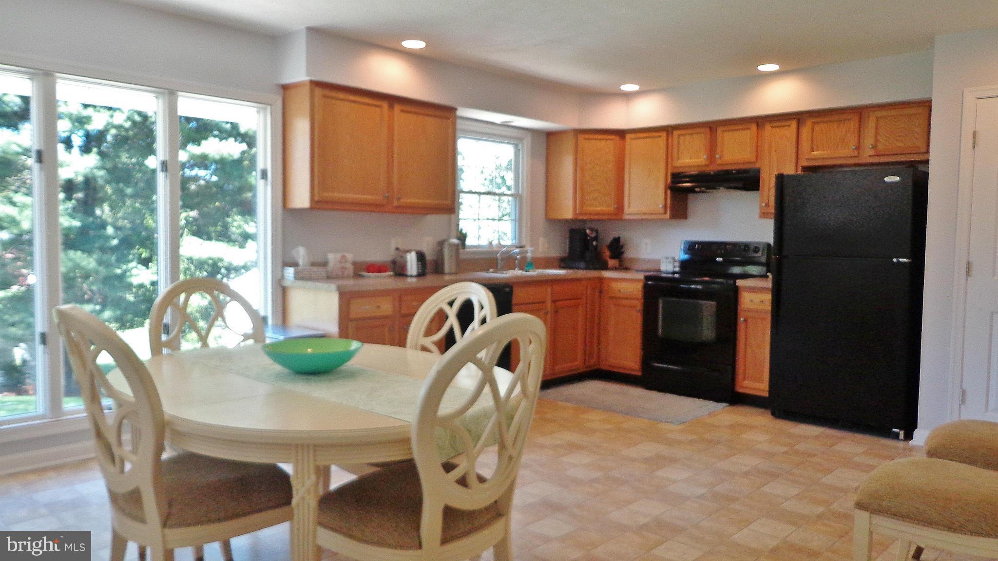 16286 Oak Shade Road Rixeyville, VA 22737 - Photo 3 of 24 a kitchen with stainless steel appliances granite countertop a stove a refrigerator a sink a table and chairs