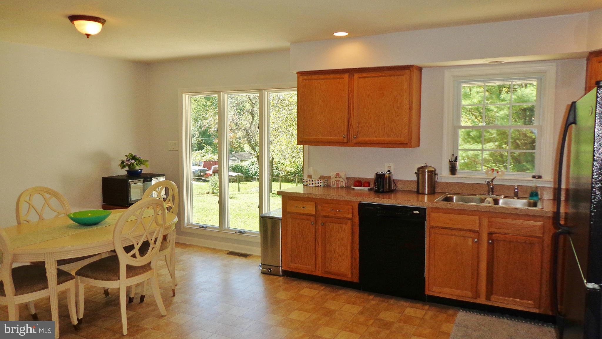 16286 Oak Shade Road Rixeyville, VA 22737 - Photo 7 of 24 a kitchen with stainless steel appliances granite countertop sink stove and wooden cabinets