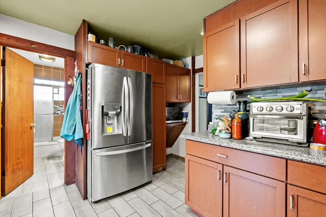a kitchen with stainless steel appliances granite countertop a refrigerator and a sink