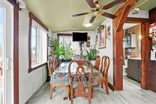 a view of a dining room with furniture and a potted plant