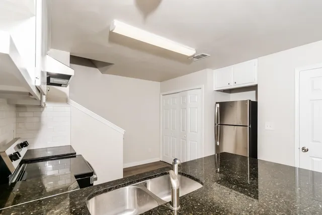 a room with gym equipment and entryway