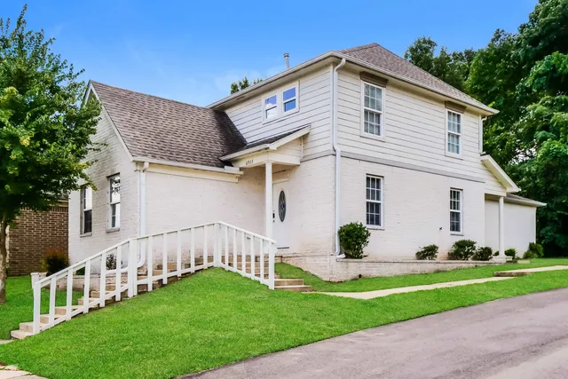 a front view of a house with garden