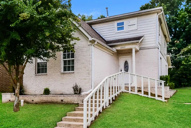 a view of house with backyard and garden