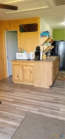 a view of a kitchen counter top space and cabinets