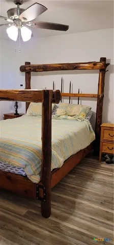 a bedroom with double vanity and a bed