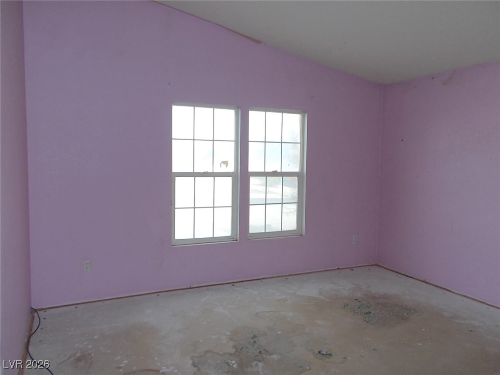 171 Paradise Road Alamo, NV 89001 - Photo 12 of 21 Spare room featuring concrete flooring and lofted ceiling