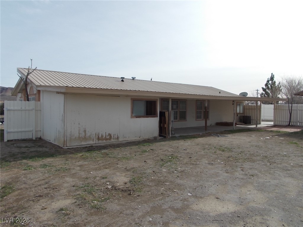 171 Paradise Road Alamo, NV 89001 - Photo 16 of 21 Rear view of house with a metal roof and a patio area