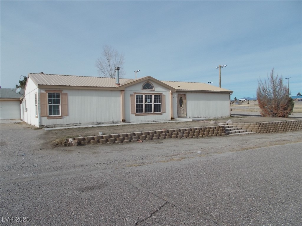 171 Paradise Road Alamo, NV 89001 - Photo 2 of 21 View of front of house featuring a metal roof and a garage