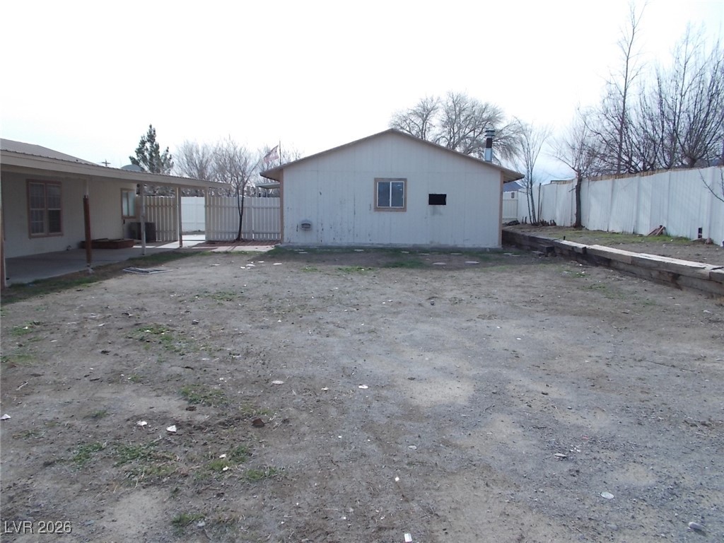 171 Paradise Road Alamo, NV 89001 - Photo 21 of 21 View of side of property with a patio area and a gate