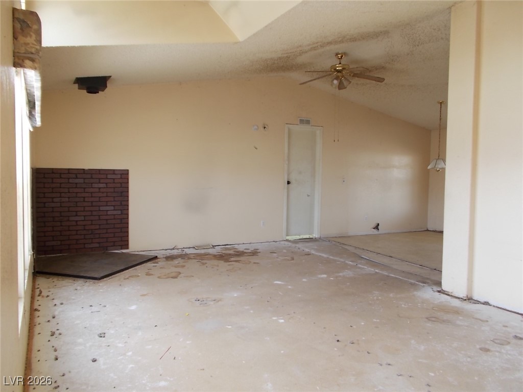 171 Paradise Road Alamo, NV 89001 - Photo 3 of 21 Empty room with vaulted ceiling and ceiling fan