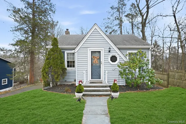 a front view of house with yard and green space