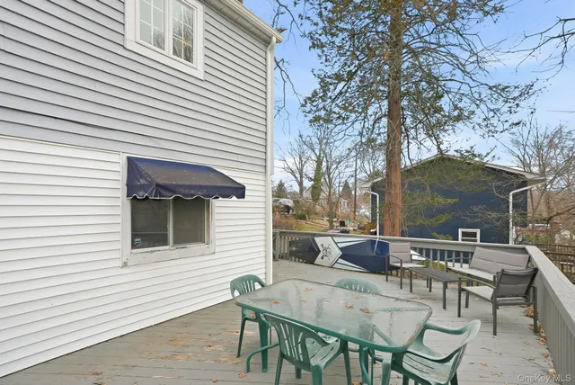 a backyard of a house with table and chairs