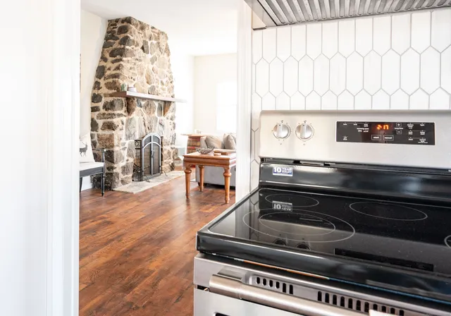 a stove top oven sitting inside of a kitchen